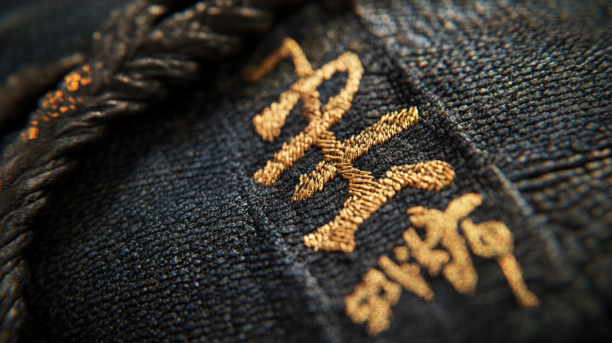 Close-up luxury gold embroidery on silk